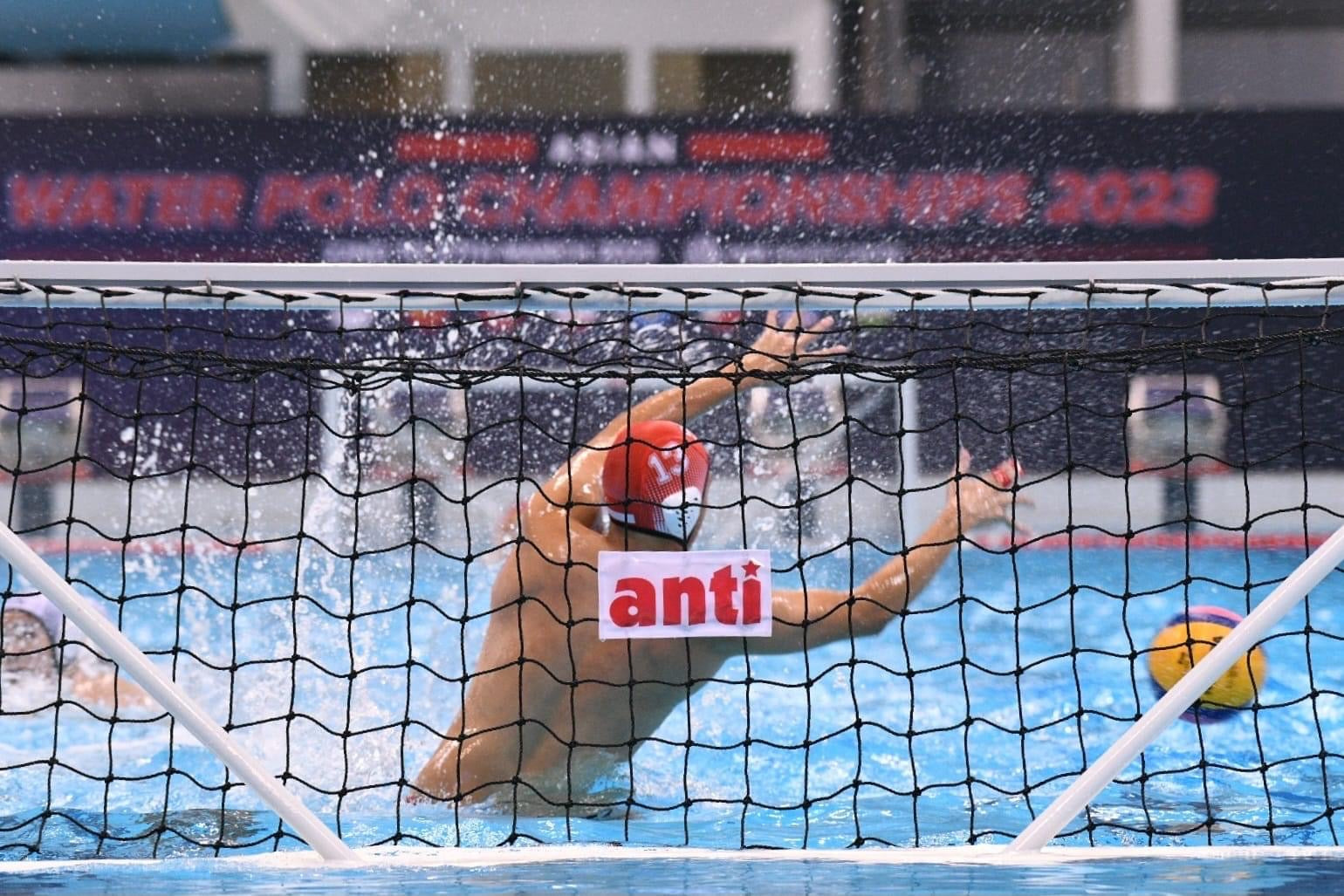 Water polo athletes competing in a swimming pool